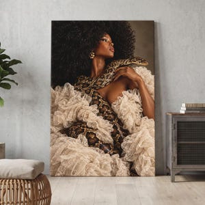 May include: A portrait of a person with voluminous dark curly hair wearing a cream-colored ruffled garment, draped with a large brown and black patterned snake. The person has gold earrings and is looking toward the right side of the frame.