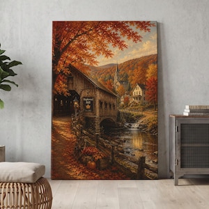 May include: A vertical canvas print depicting a rustic covered bridge labeled Maplewood Mill, surrounded by vibrant autumn foliage in shades of orange and red. A small stream flows beneath the bridge, with a church steeple visible in the distance.