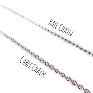 May include: Two silver chains, one labeled "Cable Chain" and the other labeled "Ball Chain".