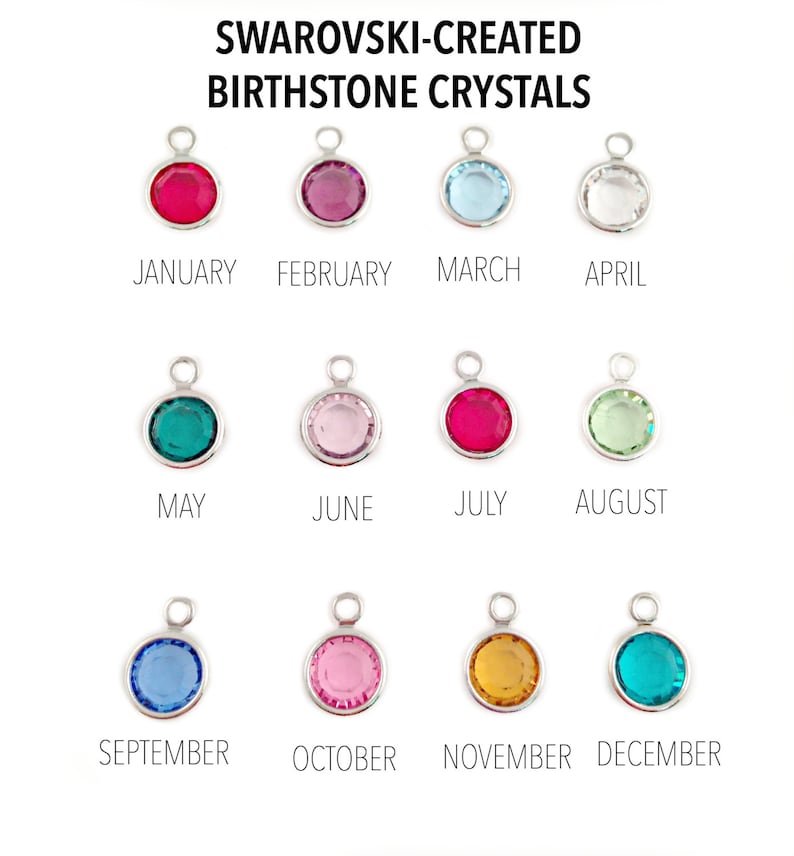 May include: Twelve round Swarovski-created birthstone crystals in silver settings. Each crystal represents a different month of the year. The crystals are arranged in three rows of four. The crystals are red, pink, light blue, clear, teal, light pink, red, light green, light blue, pink, gold, and teal.