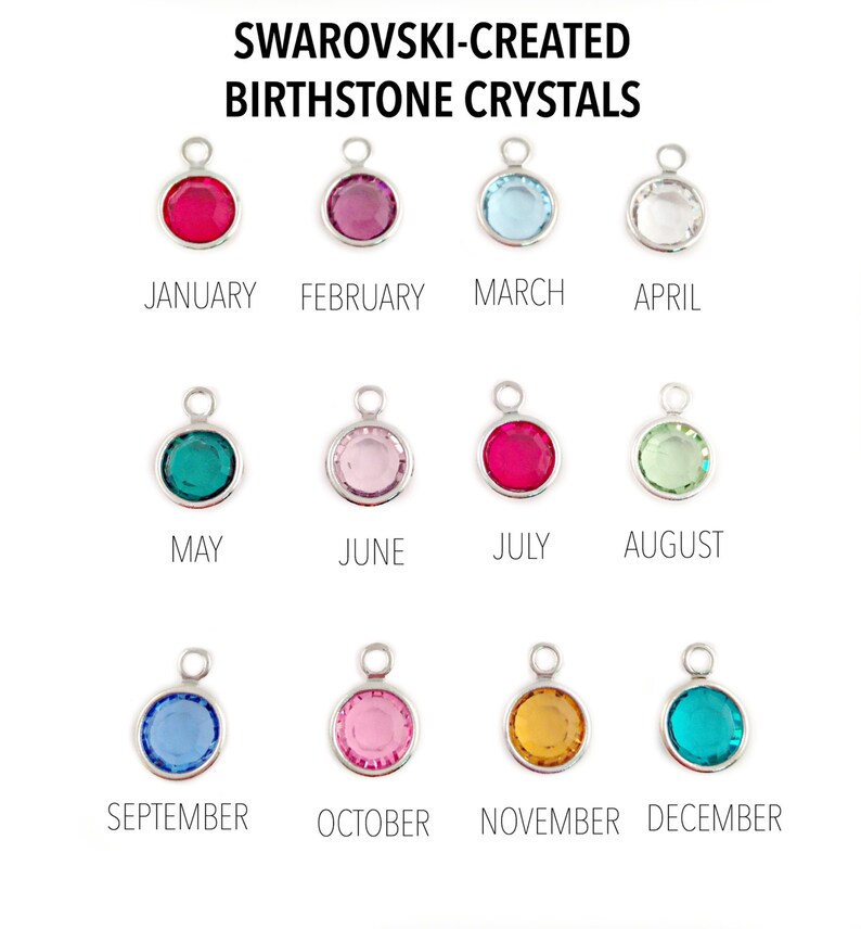 May include: Twelve round Swarovski-created birthstone crystals in silver settings. Each crystal represents a different month of the year. The crystals are arranged in three rows of four. The crystals are red, pink, light blue, clear, teal, light pink, red, light green, light blue, pink, gold, and teal.