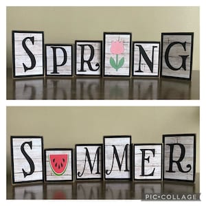 May include: Wooden block signs spelling "SPRING" and "SUMMER". The "SPRING" sign includes a pink tulip. The "SUMMER" sign includes a watermelon slice. Each block has a black border and a white and gray wood grain background.