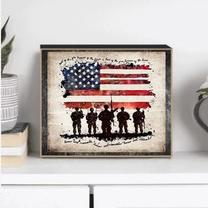 May include: A framed print with a vintage aesthetic featuring a silhouette of soldiers standing in front of an American flag. The text reads "Land of the free because of the brave. Honor and remember."