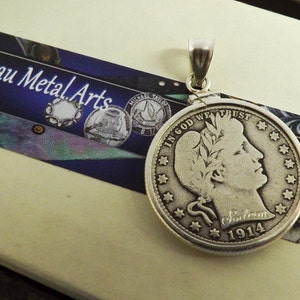 May include: Silver pendant featuring a 1914 Liberty Head nickel coin with the inscription "In God We Trust" and "Liberty 1914".