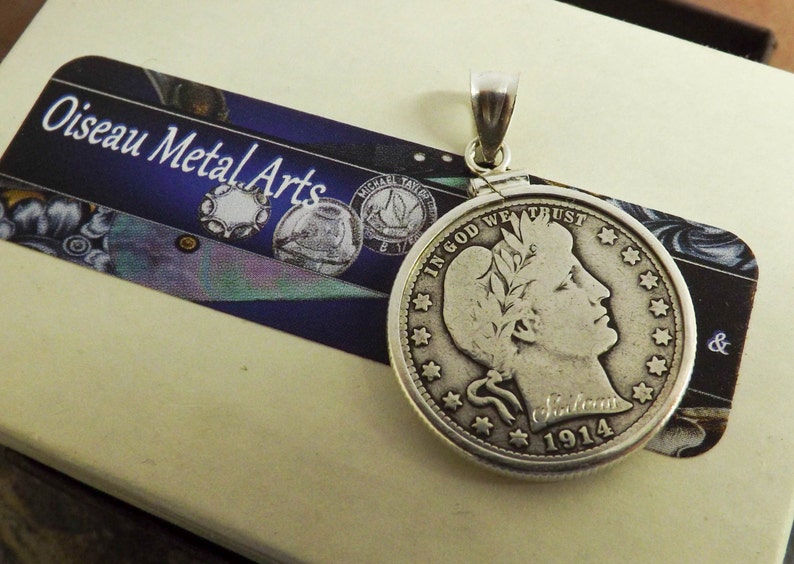 May include: Silver pendant featuring a 1914 Liberty Head nickel coin with the inscription "In God We Trust" and "Liberty 1914".