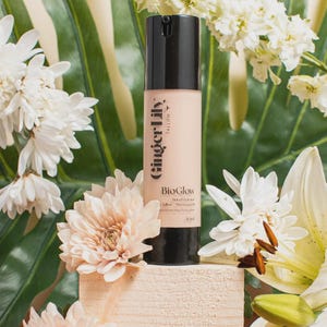 May include: A cylindrical bottle of Ginger Lily Tallow BioGlow tinted hydrator with a black pump cap. The label features the text Ginger Lily Tallow, BioGlow, Tinted Hydrator, Tallow, Moroccan Oil, and 50ml. The bottle is light beige in colour.