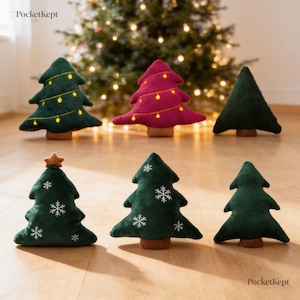 May include: Six plush Christmas tree decorations in various designs. Three are dark green, one is magenta, and two are plain dark green. Some feature embroidered yellow lights, white snowflakes, or a brown star topper. Each has a brown base.