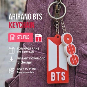 May include: A red and white keychain featuring the BTS logo and text, attached to a metal ring. The keychain includes a rectangular tag with the word BTS and a separate circular charm with three stacked red and white segments. The image includes text.
