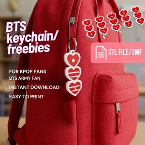 May include: A red backpack with a vertical keychain featuring three white heart-shaped charms with red geometric patterns. Text on the image includes BTS keychain/freebies, FOR KPOP FANS, BTS ARMY FAN, INSTANT DOWNLOAD, EASY TO PRINT, and STL FILE/3MF.