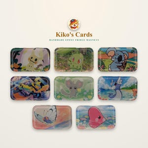 May include: Eight rectangular epoxy fridge magnets featuring colourful cartoon character illustrations. The top row shows a yellow creature, a green plant-like figure, and a blue koala. The middle row displays a dark creature, a grey mouse-like figure, and a blue dragon-like creature. The bottom row features a butterfly and a pink heart-shaped figure.