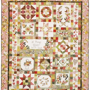 May include: A patchwork quilt featuring a floral border and various square blocks with embroidered motifs of flowers, hearts, and wreaths. The centre block displays the text "all things bloom with love" surrounded by floral illustrations in pink, green, and yellow.