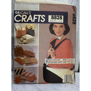 May include: McCall's Crafts sewing pattern 8828 for pouches, shoulder bags, briefcases, and tote bags. The envelope features a person wearing a shoulder bag and displays various bag designs including a clutch, a tote, and a briefcase.