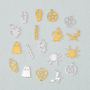 May include: A collection of metal charms in gold and silver tones featuring Halloween-themed shapes including ghosts, coffins, pentagrams, spiders, witches on broomsticks, and the word BOO. These small decorative pendants have loops for hanging.
