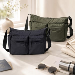 May include: Two nylon crossbody bags, one in black and one in olive green, each featuring a main zippered compartment, two front zippered pockets, side pockets, and an adjustable black shoulder strap. The bags have a soft, slightly gathered texture.
