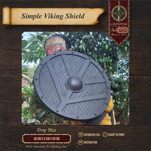 May include: A round black Viking shield prop featuring a textured wood grain pattern, a central dome, and reinforced border detailing. The shield measures 50 cm by 5 cm by 50 cm. The image includes text reading Simple Viking Shield and LARPERTIME.
