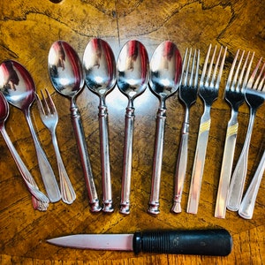 Assorted Cutlery Set of 13 pieces. Stainless steel Mismatched spoons, forks 1 antique paring knife. Small pickle fork made in Italy.