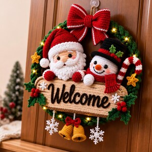 May include: A crocheted Christmas wreath featuring a Santa Claus and a snowman figure. The wreath is decorated with a large red bow, small yellow stars, green holly leaves, red berries, and white snowflakes. A central sign reads Welcome.