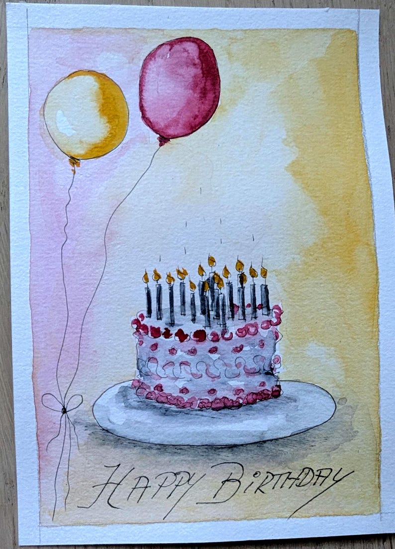May include: A watercolor painting on paper featuring a white birthday cake with pink frosting details and numerous lit candles on a plate. Two balloons, one yellow and one dark pink, float above. The text Happy Birthday is written below.