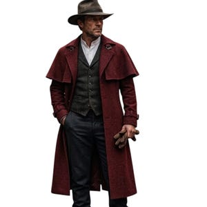 May include: A long, deep red wool-blend overcoat with a shoulder cape, worn over a dark grey vest, white collared shirt, and dark trousers. The outfit includes a brown fedora hat and brown leather gloves held in one hand, creating a layered look.