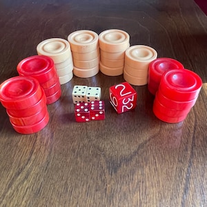 May include: A set of red and cream colored game pieces, including dice, for a board game. The dice are numbered 1, 2, 3, 4, 5, and 6.