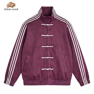 May include: A deep purple jacket featuring a high collar, long sleeves with three white stripes running down each arm, and a front closure with five white toggle buttons. The jacket includes a ribbed hem and cuffs, with the Arlow wool logo.