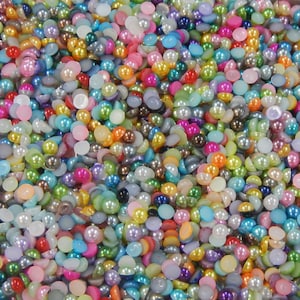 May include: A large assortment of colorful pearl-like round and flat buttons. The buttons are in various shades of pink, blue, green, yellow, and white.