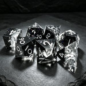 May include: A set of seven polyhedral dice made of clear resin with black ink inclusions and silver-colored numbers. The dice feature sharp edges and a mix of transparent and opaque black sections with embedded glitter particles throughout the surfaces.
