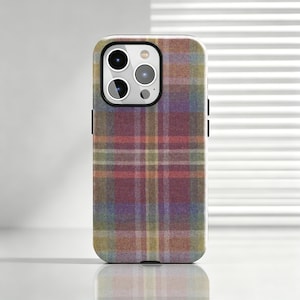 May include: A smartphone case featuring a multi-coloured tartan pattern with intersecting lines in shades of burgundy, muted blue, soft yellow, and sage green. The case has a rectangular cutout at the top left for a triple-lens camera system.