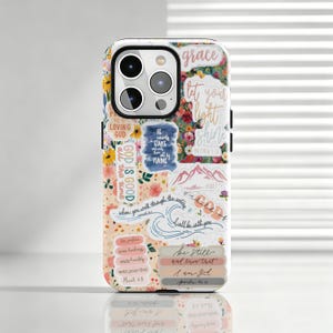 May include: A smartphone case featuring a collage of colorful floral patterns and various inspirational religious quotes including "Let your light shine," "God is good," "Be still and know that I am God," and "He counts the stars."