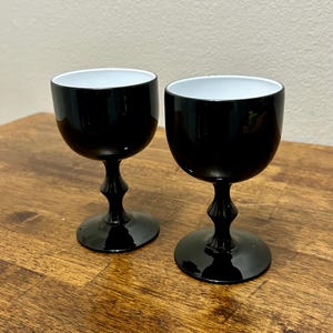 May include: A set of three ceramic mugs with a speckled, matte finish. The mugs are in shades of cream, light gray, and dark gray. Each mug has a simple, minimalist design, perfect for coffee or tea.