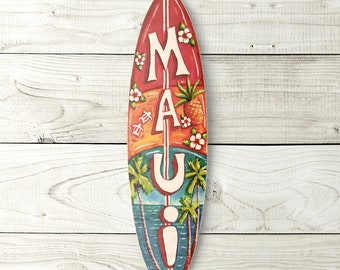 May include: A red, orange, and blue surfboard with the word "MAUI" painted on it in white letters. The surfboard is decorated with flowers, pineapples, and palm trees.