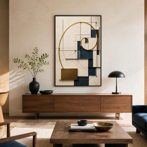 May include: A rectangular wall art piece featuring a gold metallic spiral overlaying a geometric composition of cream, navy blue, and black lines and rectangular blocks, all enclosed within a thin black frame, displayed on a light-colored wall.