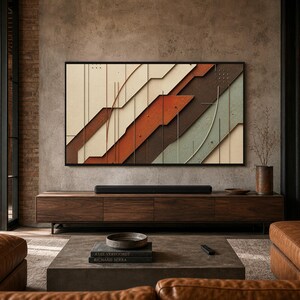 May include: A rectangular wall art piece featuring layered geometric panels in shades of cream, rust orange, dark brown, and sage green, accented with thin vertical lines. The artwork is framed in black and mounted above a long wooden media console.