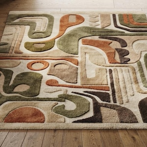 May include: A rectangular area rug featuring a high-low pile texture with an abstract pattern of curved and geometric shapes in shades of olive green, terracotta orange, dark brown, and cream. A small label in the corner reads Zeba Rugs.