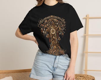 May include: A black t-shirt featuring a detailed graphic of a mechanical tree with clockwork elements, gears, and hanging pendulums. The design includes the text "WHAT WE BECOME IS BUILT BETWEEN THE MOMENTS" arched across the top of the tree.