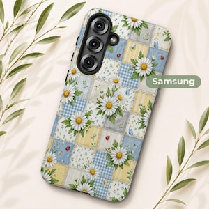 May include: A Samsung phone case featuring a patchwork design of light blue and yellow squares with white daisy flowers, small blue butterflies, and red ladybugs. The case has a triple camera cutout on the top left and the text Samsung printed.