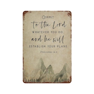 May include: A rectangular metal sign with a distressed, rust-colored border. The background is a light beige with a watercolor mountain range and forest at the bottom. It features the text: COMMIT TO THE LORD WHATEVER YOU DO, AND HE WILL ESTABLISH YOUR PLANS. PROVERBS 16:3.