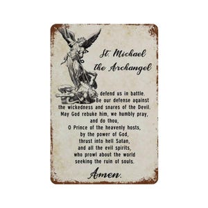 May include: A rectangular metal sign with a distressed, aged finish featuring an illustration of St. Michael the Archangel defeating Satan. The text reads: St. Michael the Archangel, defend us in battle. Be our defence against the wickedness and snares of the Devil. May God rebuke him, we humbly pray, and do thou, O Prince of the heavenly hosts, by the power of God, thrust into hell Satan, and all the evil spirits, who prowl about the world seeking the ruin of souls. Amen.