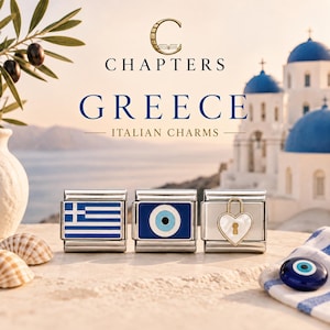 May include: Three silver-toned modular Italian charms featuring a blue and white Greek flag, a blue and white evil eye symbol, and a white heart-shaped padlock with a gold keyhole. The text reads Chapters Greece Italian Charms.