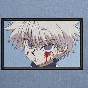 May include: A light blue t-shirt featuring a rectangular embroidered patch of an anime character with spiky white hair, purple eyes, and red blood-like markings on the face, enclosed within a thin black border on the fabric surface.