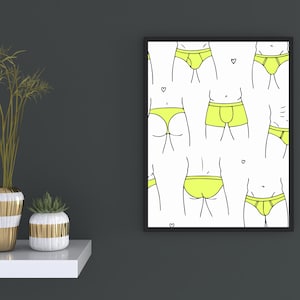 Puede incluir: Una impresión de arte mural enmarcada que presenta un patrón repetitivo de varios estilos de ropa interior en color amarillo brillante sobre un fondo blanco, acentuado con pequeños corazones dibujados en línea negra dispersos.