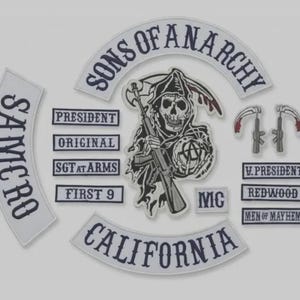May include: A set of embroidered patches featuring the Sons of Anarchy logo, including a central grim reaper holding a rifle and an anarchy symbol, curved rockers reading Sons of Anarchy and California, and rectangular patches with titles like President.