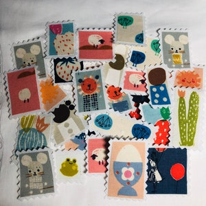 May include: A collection of colourful fabric squares with various animal and nature designs. The squares are cut in the shape of postage stamps and feature illustrations of a mouse, sheep, lion, frog, and a cactus.