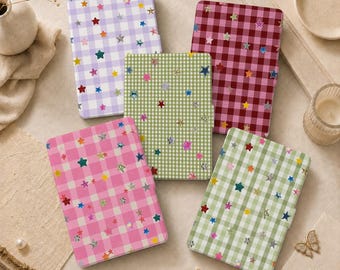 May include: Five rectangular notebooks with gingham check patterns in lavender, dark red, light green, bright pink, and sage green. Each notebook cover is decorated with scattered, multi-colored, metallic-finish star shapes of various sizes.