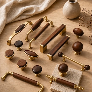 May include: A collection of cabinet hardware featuring various drawer pulls and knobs made from dark brown wood and brushed brass metal. The set includes rectangular, cylindrical, and oval-shaped handles, along with round knobs in different sizes.