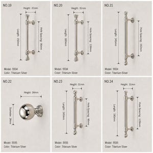 May include: A collection of titanium silver cabinet hardware including five bar pulls and one round knob. Each item is labeled with model numbers 5934 or 5935, showing specific metric dimensions for length, height, and hole spacing for each piece.