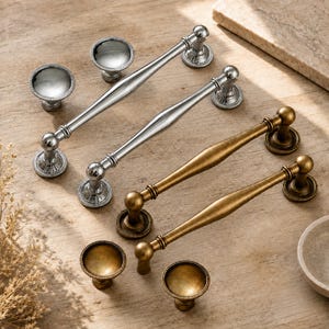 May include: A collection of cabinet hardware including two polished chrome drawer pulls, two antique brass drawer pulls, two polished chrome knobs, and two antique brass knobs. Each piece features a rounded base with a beaded edge detail.