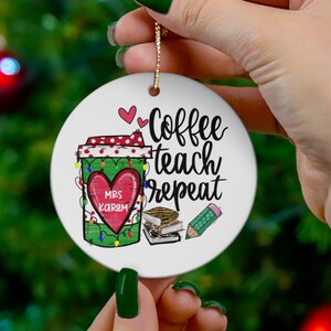 May include: A white round Christmas ornament with a green coffee cup with lights, a red heart with the text "Mrs. Karen", and the text "Coffee teach repeat".