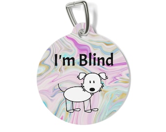 May include: A round pet tag with a silver metal attachment loop, featuring a swirling pink, blue, and gold marble pattern. The text "I'm Blind" is printed in black above a simple black and white line drawing of a small dog with floppy ears.