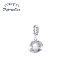 May include: A silver charm featuring a shell design with a central white pearl and small clear stones embedded in the shell surface. The charm includes a circular bail decorated with small clear stones and the text Charmtasticss above it.